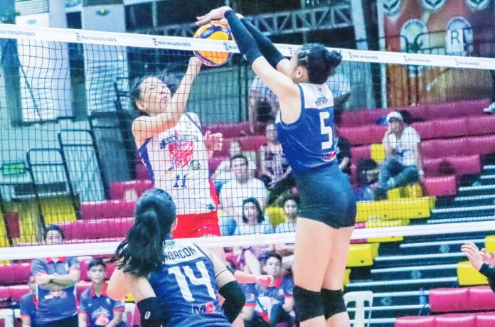sports_negros_resized Negros ICC Blue Hawks’ Christine Joy Apan with a two-handed block against a San Juan Lady Knights Go For Gold player. Photo courtesy of MPVA PHOTO