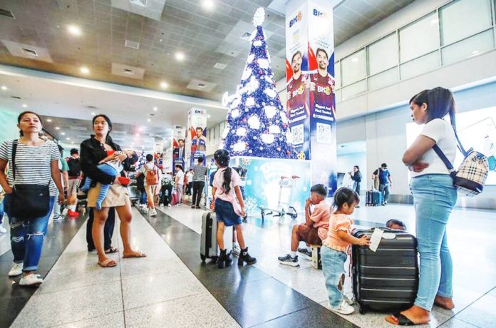 travel_rush_copy_resized Travelers arrive at the Ninoy Aquino International Airport Terminal 3 in Pasay City for their respective flights on Dec. 13. JONATHAN CELLONA/ABS-CBN NEWS PHOTO