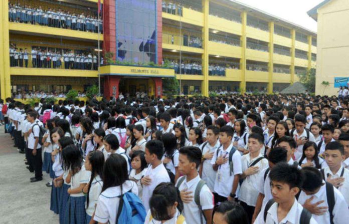 CHED_resized High school students attend a flag raising ceremony at a government school in Quezon City. AFP