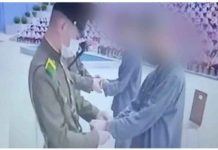 Two North Korean teenagers are handcuffed after their conviction for watching South Korean TV shows. BBC
