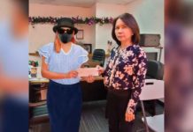 Assistant General Manager Juliet F. Aseo turn over the cheque to the sole winner of Lotto 6/42 on December 29, 2023.