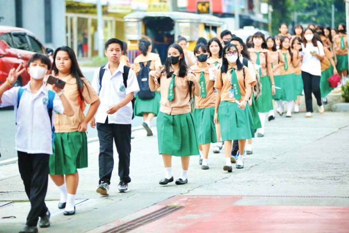ched Students of the Quezon City High School troop to their school along Scout Ybardolaza Street, Barangay Sacred Heart, Quezon City. The Department of Education says there are over 22.9 million students from public and private schools from kindergarten to senior high school in school year 2023-2024. PNA