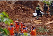 Members of a rescue team search for people trapped at the area of a landslide in the road between Quibdo and Medellin, Choco department, Colombia on Jan. 13, 2024. GETTY IMAGES