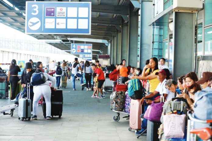 fuel_surcharge_resized Air travelers should expect lower fares after the Civil Aeronautics Board lowered the fuel surcharge applicable for February from Level 6 to Level 5. Photo shows passengers waiting for their flights outside the Ninoy Aquino International Airport Terminal 3 in Pasay City. PNA PHOTO BY AVITO C. DALAN