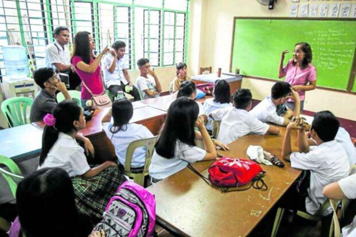nation_senior_high_resized File photo shows a teacher at the Ramon Magsaysay (Cubao) High School in Quezon City discussing lessons with her students. INQUIRER PHOTO