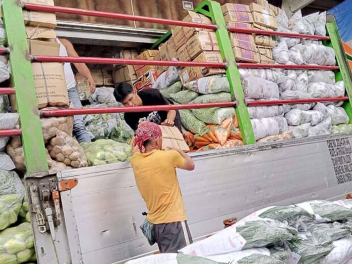 nation_veggie_resized Workers at the vegetable trading post in La Trinidad, Benguet, keep up with the arrival of delivery trucks unloading freshly harvested vegetables from farms in the province and other areas in the Cordillera region. File photo by ALLAN MACATUNO / Inquirer Northern Luzon