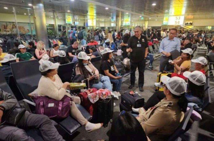 ofw_resized Ambassador Alfonso Ferdinand Ver and Consul General Marford Angeles of Embassy of the Philippines in United Arab Emirates meet 39 overseas Filipino workers (OFWs) from Israel while in transit at Abu Dhabi International Airport. They comprise the 7th batch of OFWs to return to the Philippines since Israel-Hamas conflict broke out in early October. File photo from DEPARTMENT OF MIGRANT WORKERS Facebook page
