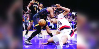 Phoenix Suns’ Josh Okogie battles for the loose ball with Portland Trail Blazers’ Moses Brown (10). PHOTO COURTESY OF CHRIS CODUTO/GETTY IMAGES