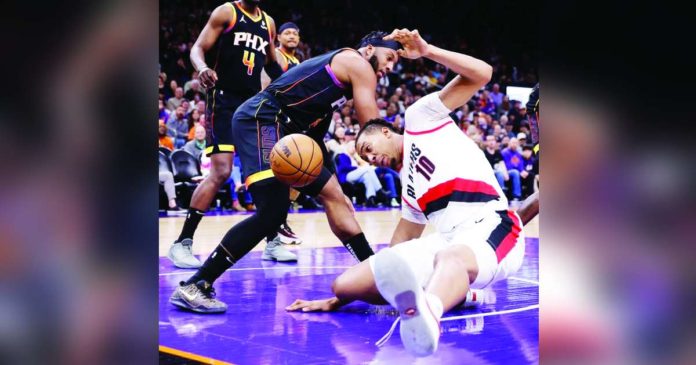 sports durant_superimposed Phoenix Suns’ Josh Okogie battles for the loose ball with Portland Trail Blazers’ Moses Brown (10). PHOTO COURTESY OF CHRIS CODUTO/GETTY IMAGES