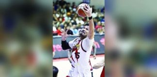 San Miguel Beermen’s June Mar Fajardo towers over his Barangay Ginebra San Miguel Kings’ defenders for a rebound. PBA PHOTO
