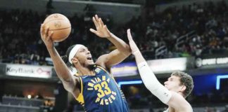 Indiana Pacers’ Myles Turner goes for a hook shot against the defense of Milwaukee Bucks’ Brook Lopez. AP PHOTO