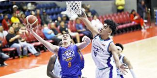 NLEX Road Warriors’ Robert Bolick Jr. goes for a layup against the defense of Converge FiberXers’ Justin Arana. PBA PHOTO