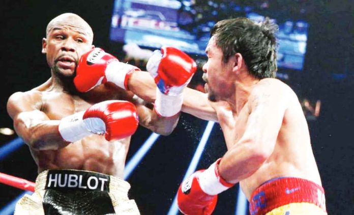 sports_Pacquiao.JPG_resized Manny Pacquiao lands a punch against Floyd Mayweather Jr. during their first encounter on May 3, 2015. PHOTO COURTESY OF ESTHER LIM/SHOWTIME