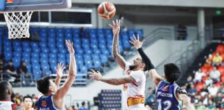 Rain or Shine Elasto Painters’ Nicholas Demusis attempts a floater against the defense of Converge FiberXers’ Bryan Santos. PBA PHOTO