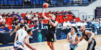 TNT Tropang Giga’s Roger Pogoy scores on a floater against the defense of Phoenix Super LPG Fuel Masters’ Johnathan Williams III. PBA PHOTO