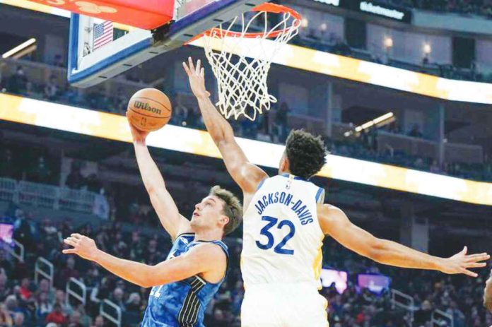 sports_golden_resized Golden State Warriors’ Trayce Jackson-Davis attempts to block the shot of Orlando Magic’s Franz Wagner. PHOTO COURTESY OF LOREN ELLIOT/AP