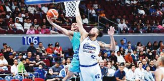 Phoenix Super LPG Fuel Masters’ Javee Mocon goes for a tough basket against the defense of Magnolia Chicken Timplados Hotshots’ James Laput. PBA PHOTO