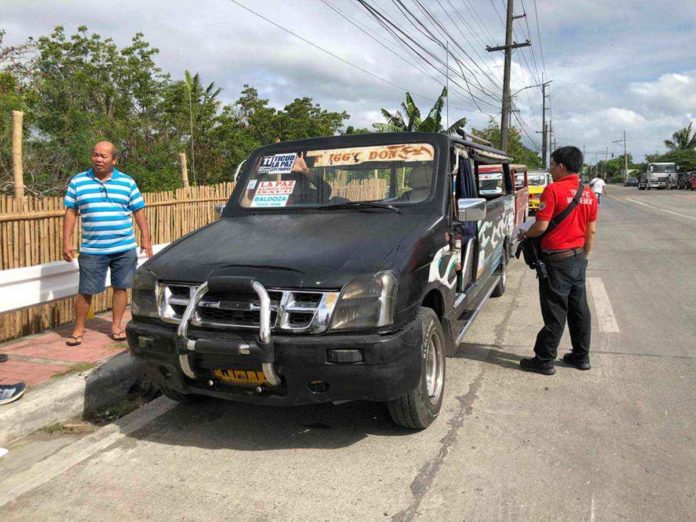 stickering_pic_resized Personnel of the Iloilo City Traffic Management Unit distribute stickers to consolidated public utility jeepneys. ILOILO CITY TRAFFIC MANAGEMENT UNIT PHOTO