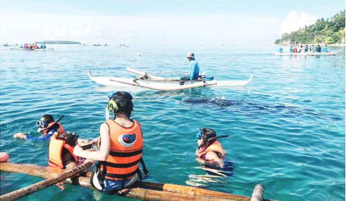 tourists.JPG_resized Cebu ranked 19th in Travel Lemming’s list of 50 ‘Best Places to Travel’ in 2023. Photo shows tourists swimming with whale sharks in Oslob, Cebu. PHOTO COURTESY OF ABS-CBN NEWS