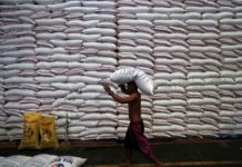 Agri dep’t probes alleged improper NFA rice sale A worker carries on his head a sack of rice inside a government rice warehouse National Food Authority in Quezon City. The Department of Agriculture says President Ferdinand Marcos Jr. will seriously think about a proposal that would give rice – instead of cash – to beneficiaries of the Pantawid Pamilyang Pilipino Program). REUTERS/ERIK DE CASTRO/FILES
