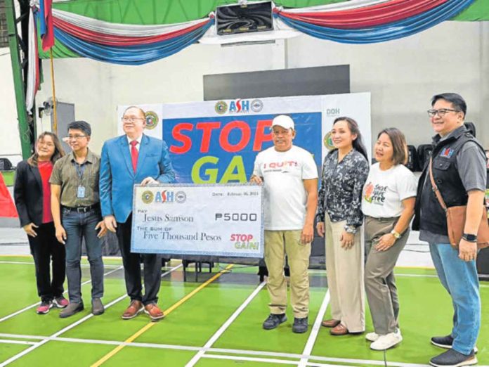 Jesus Samson, 51 (wearing a cap), was among the 1,100 participants of “Stop and Gain,” the first-ever smoking cessation contest in the country organized by the Department of Health in partnership with the Lung Center of the Philippines and Action on Smoking and Health (ASH) Philippines. He was among the three grand prize winners, the other two from Baguio City and Kalibo, Aklan. PHOTO FROM ASH PHILIPPINES