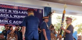 Newly installed Police Regional Office 6 (PRO-6) director Brigadier General Jack Wanky receives the PRO-6 flag from Philippine National Police chief General Benjamin Acorda Jr., during a turnover ceremony on Monday, Feb. 19.