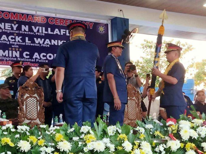 Newly installed Police Regional Office 6 (PRO-6) director Brigadier General Jack Wanky receives the PRO-6 flag from Philippine National Police chief General Benjamin Acorda Jr., during a turnover ceremony on Monday, Feb. 19.