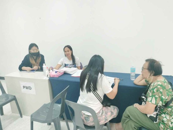 A person with disability is processing her new identification card at the Government Services Express at a mall in Bacolod City. MAE SINGUAY/PN