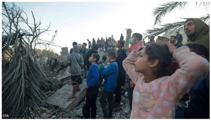 china.JPG_resized Palestinians watch as people search for bodies and survivors among the rubble following Israeli airstrikes on the west of Al Nusairat refugee camp, southern Gaza Strip. EPA