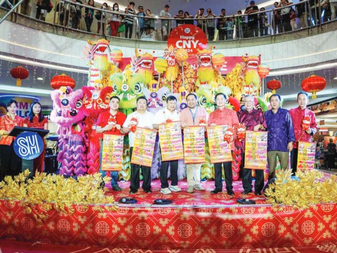 front_pic_resized HARMONY IN BLOSSOM. Iloilo City’s Mayor Jerry P. Treñas (3rd from left), Filipino-Chinese community leaders (from extreme left) Rex Chua and Ian Pama, SM City Iloilo Assistant Mall Manager Darrel John Defensor, Terence Uygongco, Charles Hi, Danny Tan Chan, and Warren Uy pose for a souvenir photo after the grand opening of the Iloilo City Chinese New Year celebration at the Event Center of SM City Iloilo on Feb. 6. Themed “Harmony in Blossom: 20 Years of Cultivating Filipino-Chinese Unity”, the week-long celebration welcomes the Lunar New Year. The open program was capped with dragon and lion dances and a cultural presentation by the students and staff of Chinese-Filipino schools in Iloilo City.