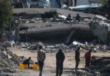 Israel-Gaza war: Latest ceasefire talks not very promising – Qatar People walk next to destroyed houses in the Gaza Strip. EPA