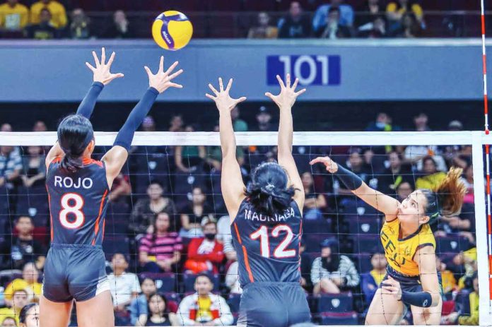 sports_FEU_resized Far Eastern University Lady Tamaraws’ Gerzel Petallo slams the ball towards two University of the East Lady Warriors defenders. UAAP PHOTO