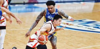 San Miguel Beermen’s Jeron Teng dribbles the ball away from the defense of Magnolia Chicken Timplados Hotshots’ Tyler Bey. PBA PHOTO