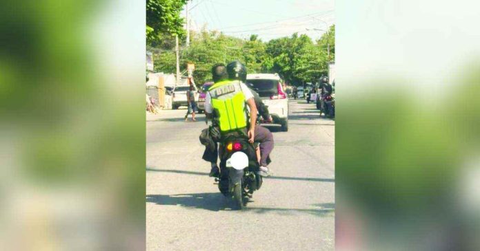 traffic enforcer_superimposed This Bacolod Traffic Authority Office enforcer was seen backriding on a motorcycle with no helmet. CONTRIBUTED PHOTO