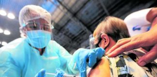 A nurse vaccinates a senior citizen against coronavirus disease 2019. INQUIRER FILE PHOTO