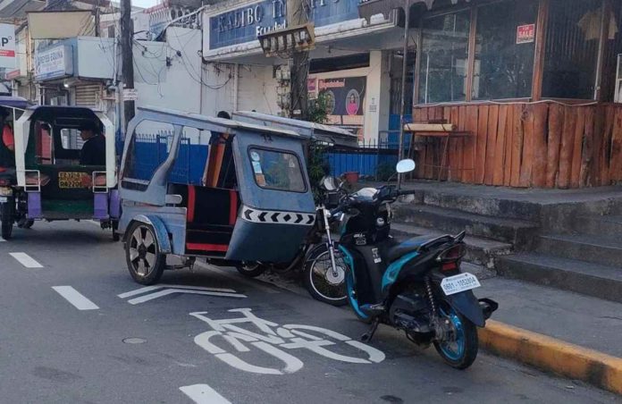 Vehicles parking on bike lanes in Kalibo, Aklan for extended periods will get citation tickets from the Land Transportation Office and Highway Patrol Group. The photo shows some motorists using the bike lane on Mabini Street. AKLAN NEWS FORUM