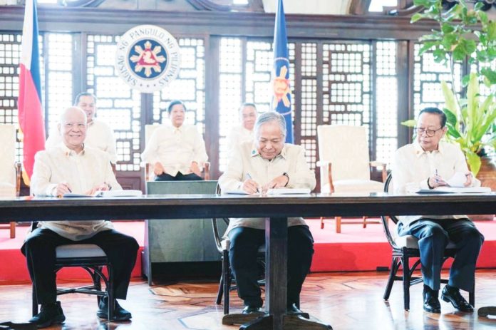 PPP_deal_resized (From left) San Miguel Corp. president Ramon S. Ang, Transportation Secretary Jaime Bautista and Manila International Airport Authority General Manager Eric Jose Ines signed the public-private partnership agreement for the rehabilitation of the Ninoy Aquino International Airport on Monday, March 18. The signing was witnessed by President Ferdinand Marcos Jr. BONGBONG MARCOS/FACEBOOK PHOTO