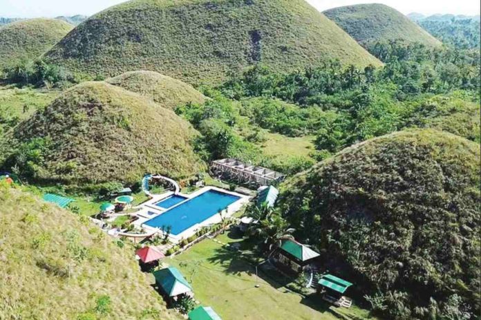 The business permit of this controversial resort has been canceled after it drew backlash and concern from netizens over its proximity to the iconic Chocolate Hills. PHOTO COURTESY OF ABS-CBN NEWS