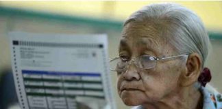 An elderly woman checks her ballot paper in this undated election photo. Last year, the Commission on Elections had a test run of earlier voting for senior citizens, persons with disabilities, and pregnant women in some areas. AFP/GETTY IMAGES