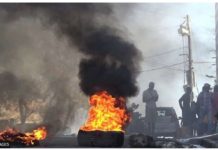 Gangs threaten Haiti gov’t takeover Tires are set on fire outside the main prison in the Haitian capital, Port-au-Prince. GETTY IMAGES