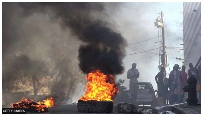 haiti.JPG_resized Tires are set on fire outside the main prison in the Haitian capital, Port-au-Prince. GETTY IMAGES