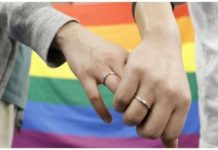 Plaintiffs hold hands after a district court ruled on the legality of same-sex marriages outside Sapporo district court in Sapporo, Japan. REUTERS