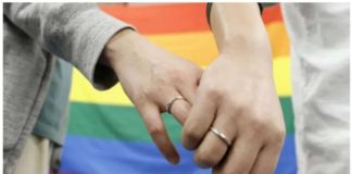 Plaintiffs hold hands after a district court ruled on the legality of same-sex marriages outside Sapporo district court in Sapporo, Japan. REUTERS