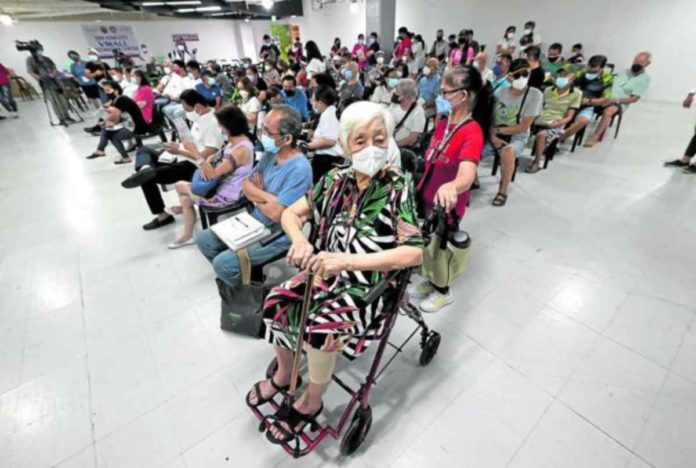 nation senior Senior citizens wait for their turn to get their second booster shot of COVID-19 vaccine at a mall on May 20, 2022. Philippine Daily Inquirer/ GRIG MONTEGRANDE)