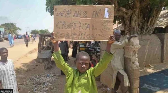 nigeria A boy holds a sign to protest against the kidnapping of nearly 300 schoolchildren this week. REUTERS