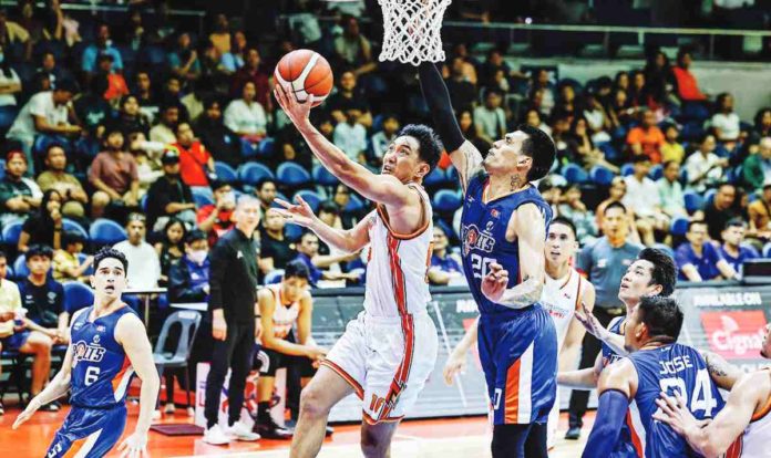 Negrense Jeffrei Chan of NorthPort Batang Pier evades the defense of Meralco Bolts’ Raymond Almazan for a reverse layup. PBA PHOTO