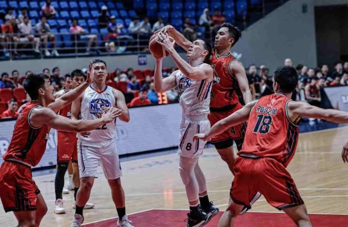 NLEX Road Warriors’ Robert Bolick Jr. had his shot blocked by the defense of Blackwater Bossing’s Rey Suerte. PBA PHOTO