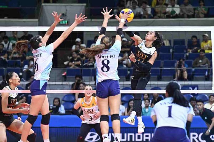 University of Santo Tomas Golden Tigresses’ Angeline Poyos goes for an attack against the defense of Adamson University Lady Falcons’ AA Adolfo. UAAP PHOTO