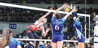 University of the East Lady Warriors’ Casiey Dongallo scores against the double-block defense of Adamson University Lady Falcons. UAAP PHOTO