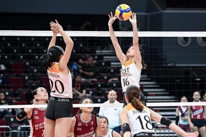 sports_UST_resized Negrense Cassie Carballo of the University of Santo Tomas Golden Tigresses tosses the ball to her teammates. UAAP PHOTO